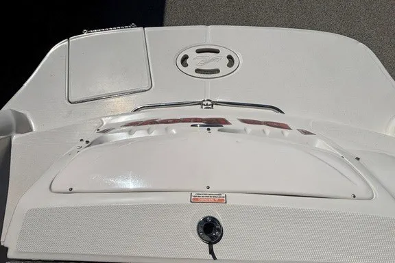 Slide: The Image of The image shows the stern of a 2004 Sea Ray 200 Sundeck boat with a swim platform. - 12