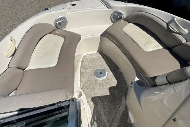 Slide: The Image of 2004 Sea Ray 200 Sundeck interior with beige seating and carpeted floor. - 7