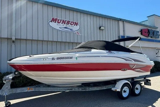 The Image of 2004 Sea Ray 200 Sundeck boat on trailer, parked outside Munson Ski & Marine building. - 0