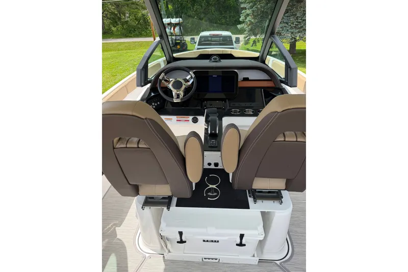 Slide: The Image of Interior view of 2027 Monterey Elite 25 OB boat cockpit with dual seats and steering wheel. - 15