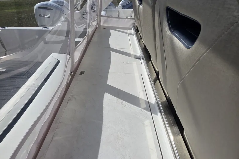Slide: The Image of 2024 Tiara Sport 34LS boat walkway with Yamaha engines, featuring sleek design and comfortable seating. - 26