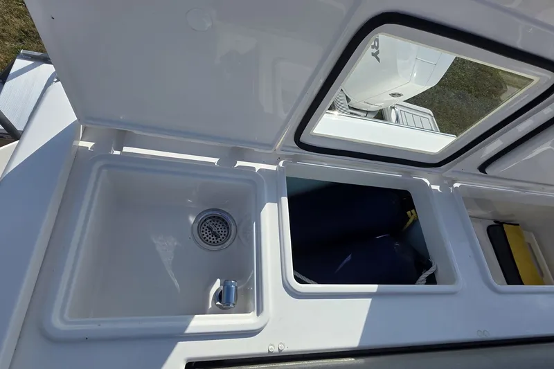 Slide: The Image of 2024 Tiara Sport 34LS boat storage compartments and sink detail. - 16
