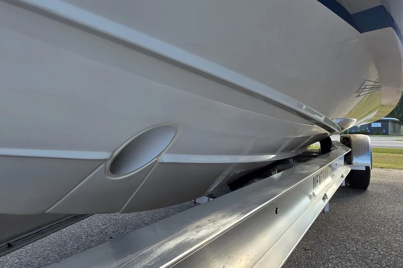 Slide: The Image of 2024 Tiara Sport 34LS boat hull on trailer, showcasing sleek design and craftsmanship. - 24
