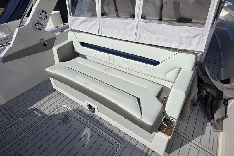 Slide: The Image of 2024 Tiara Sport 34LS boat seating area with luxurious upholstery and cup holder. - 28