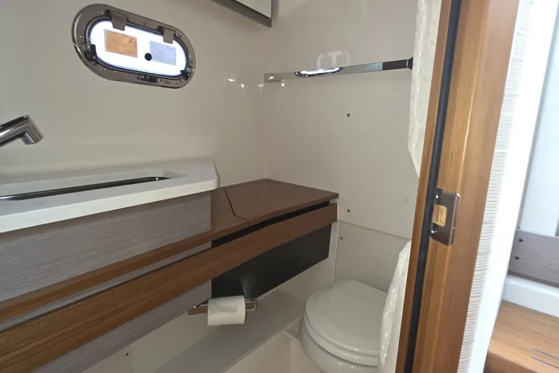 Slide: The Image of 2024 Tiara Sport 34LS boat bathroom with modern fixtures and wooden accents. - 23