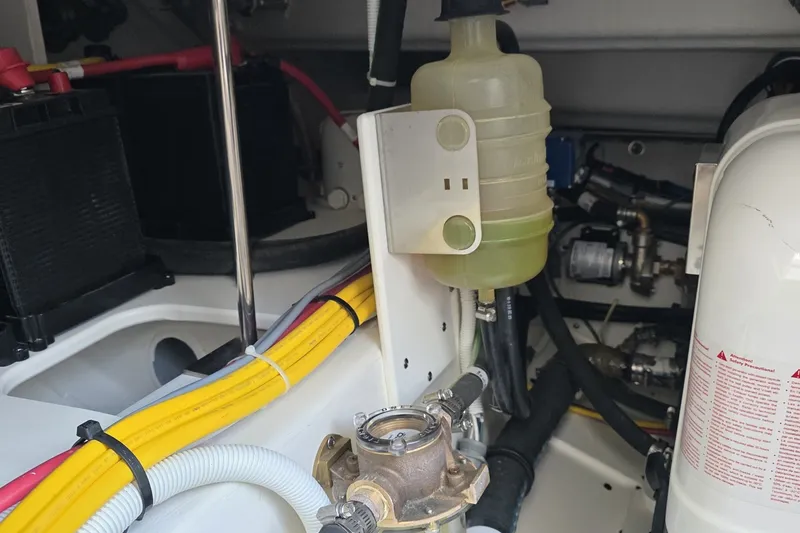 Slide: The Image of Engine compartment of 2024 Tiara Sport 34LS, showcasing wiring and fluid reservoir. - 41