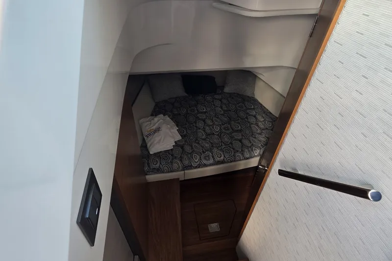 Slide: The Image of 2024 Tiara Sport 34LS cabin interior with cozy bed and modern design. - 19
