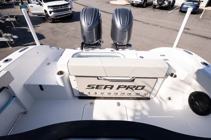Slide: The Image of 2027 Sea Pro 262 Offshore boat with dual engines, parked in a marina lot. - 17