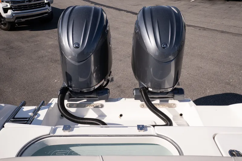 Slide: The Image of 2027 Sea Pro 262 Offshore boat with dual outboard engines, parked on pavement. - 20