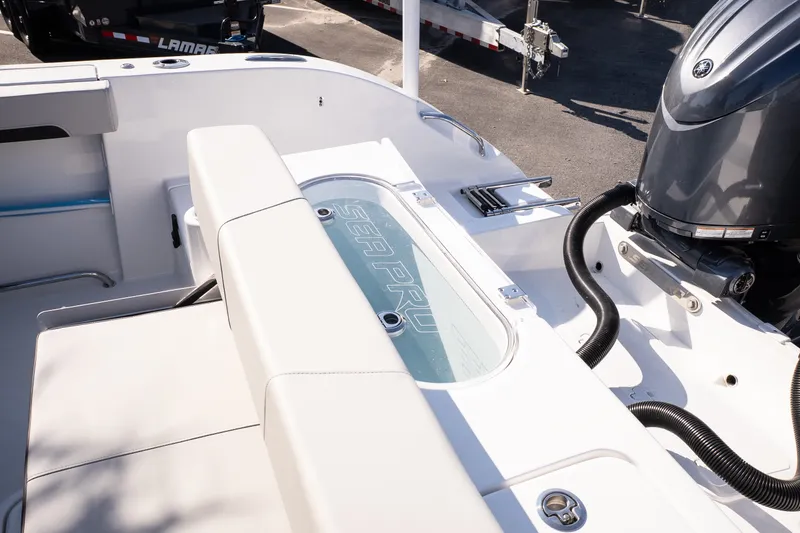 Slide: The Image of 2027 Sea Pro 262 Offshore boat interior with seating and engine view. - 19