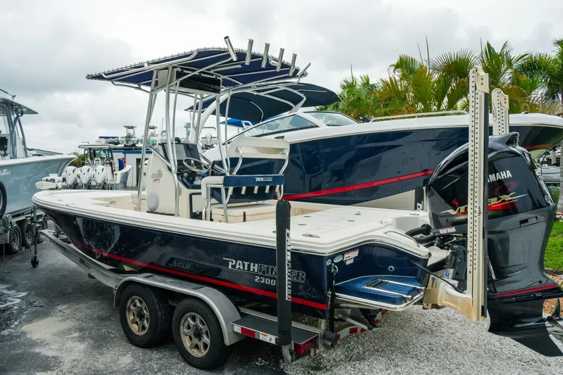 The Image of 2021 Pathfinder 2300 HPS boat on trailer, featuring Yamaha outboard motor. - 1