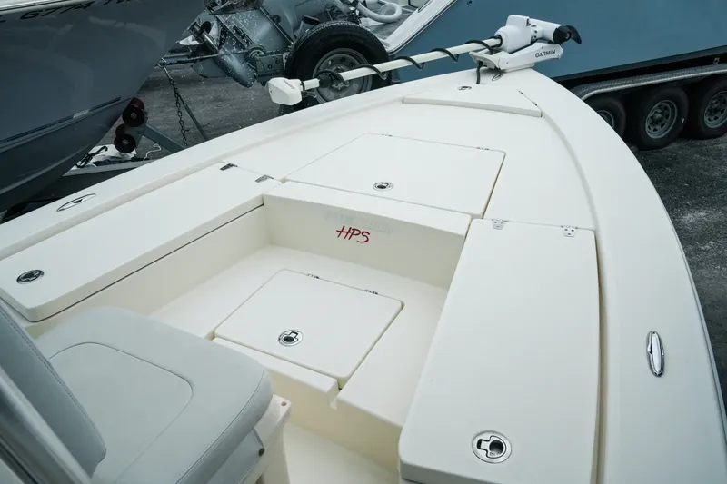 Slide: The Image of 2021 Pathfinder 2300 HPS boat deck with storage compartments and Garmin equipment. - 15