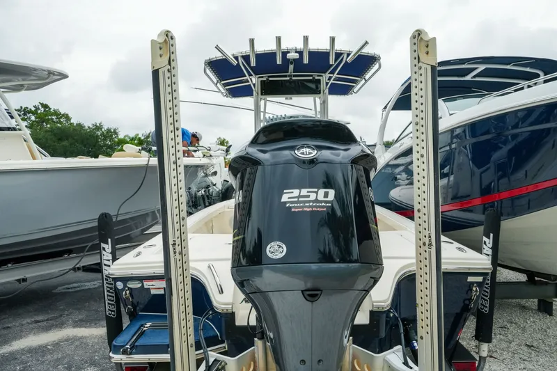 Slide: The Image of 2021 Pathfinder 2300 HPS boat with Yamaha 250 engine, docked among other boats. - 5
