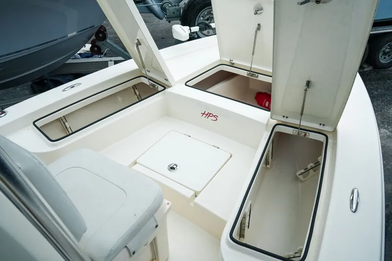 Slide: The Image of 2021 Pathfinder 2300 HPS boat interior with open storage compartments and seating. - 17