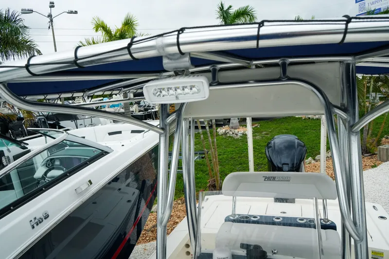 Slide: The Image of 2021 Pathfinder 2300 HPS boat with T-top and seating, displayed outdoors. - 20