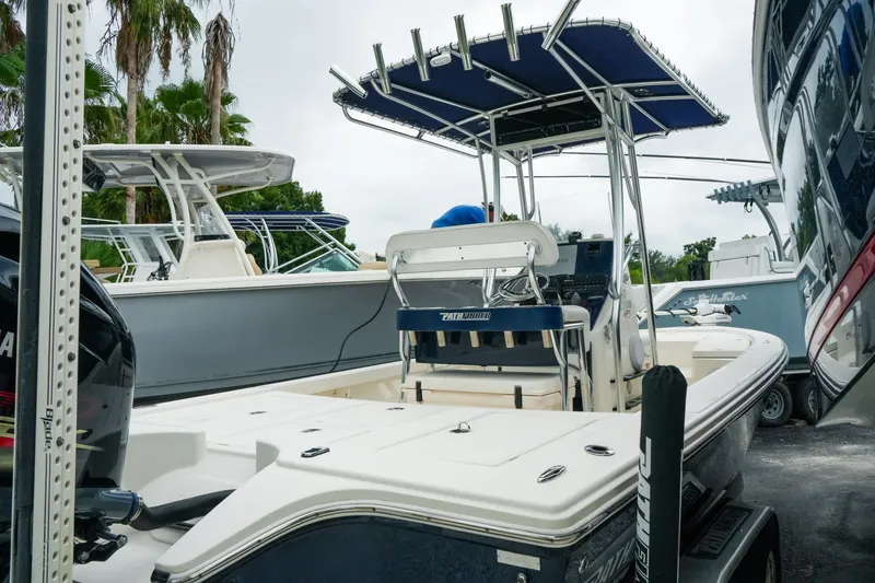 Slide: The Image of 2021 Pathfinder 2300 HPS boat with T-top and Yamaha engine, docked outdoors. - 7