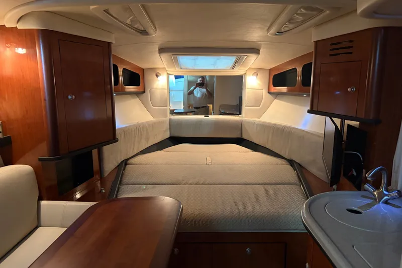 Slide: The Image of Interior of 2006 Sea Ray 290 Sundancer boat, featuring cozy cabin and modern amenities. - 14