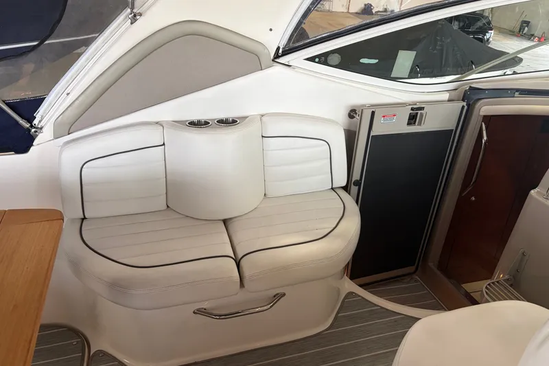 Slide: The Image of Interior seating of a 2006 Sea Ray 290 Sundancer boat with cup holders. - 8