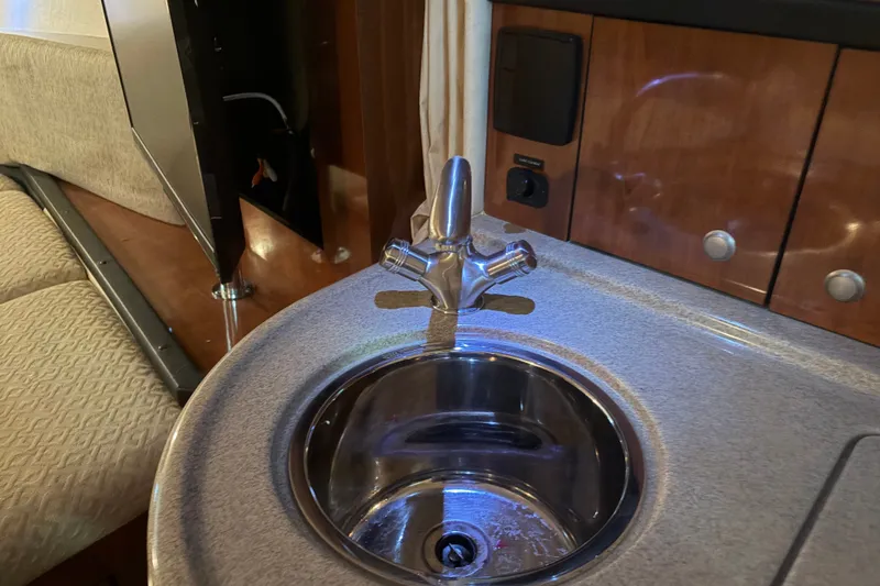 Slide: The Image of 2006 Sea Ray 290 Sundancer interior with sink and faucet in cabin area. - 19