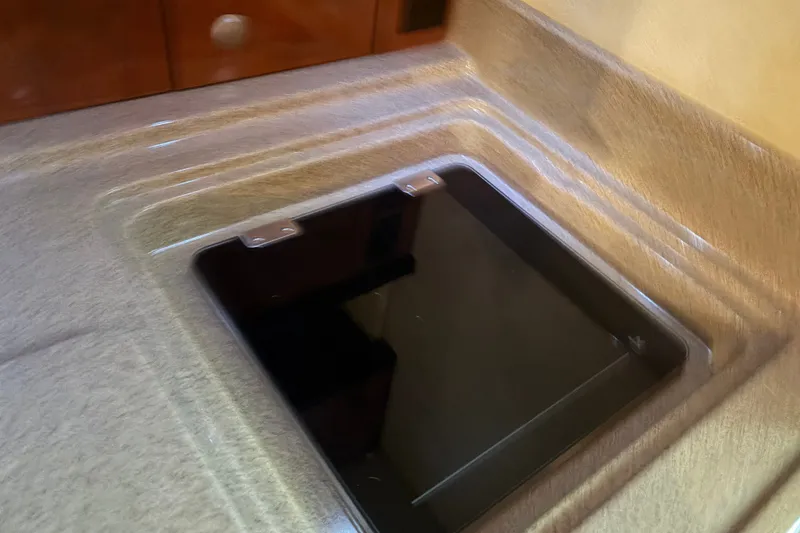 Slide: The Image of 2006 Sea Ray 290 Sundancer interior countertop with integrated stove cover. - 20