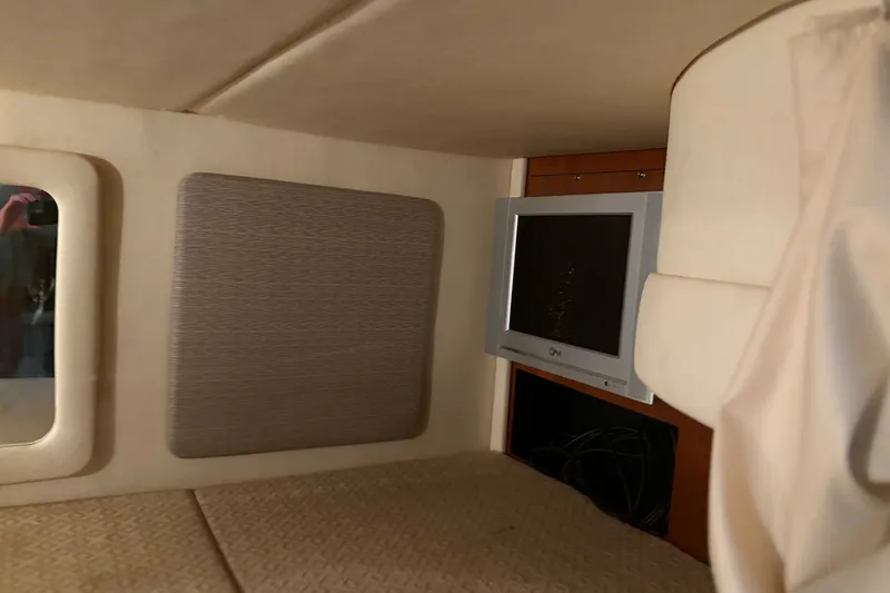 Slide: The Image of Interior cabin of 2006 Sea Ray 290 Sundancer with TV and cushioned walls. - 25