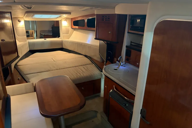 Slide: The Image of Interior of 2006 Sea Ray 290 Sundancer boat with cozy cabin and kitchenette. - 12
