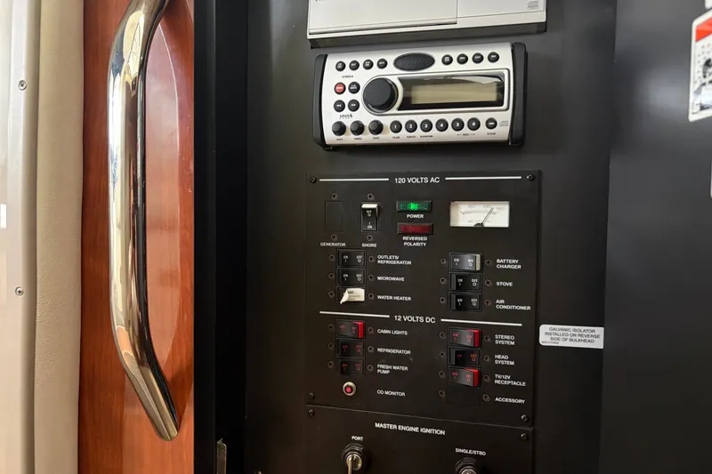 Slide: The Image of Control panel of a 2006 Sea Ray 290 Sundancer boat, featuring various switches and a stereo system. - 15
