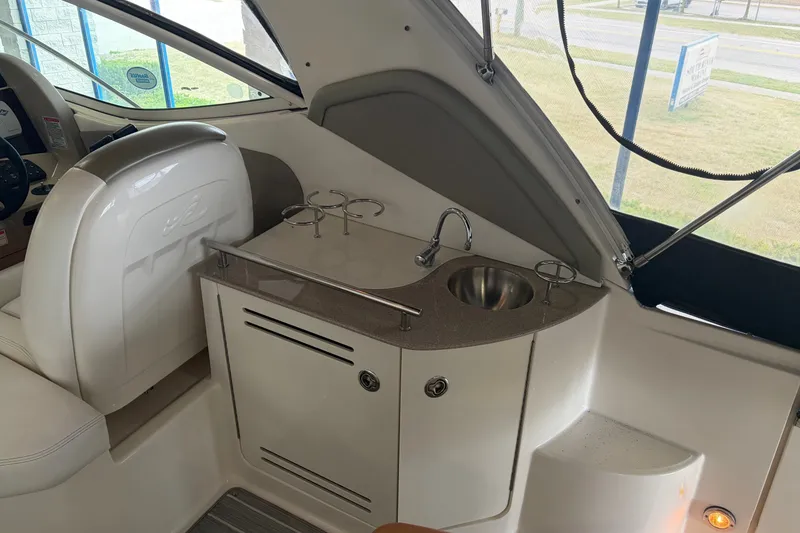 Slide: The Image of 2006 Sea Ray 290 Sundancer interior with sink and storage area. - 6