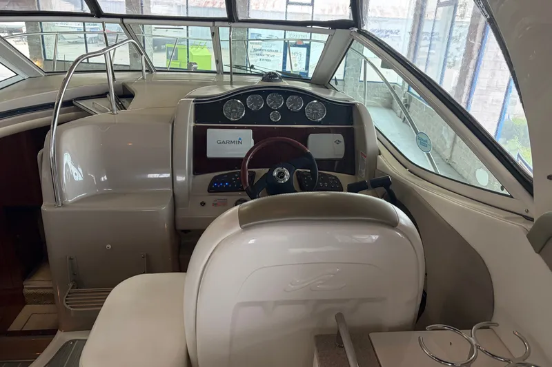 Slide: The Image of Interior view of 2006 Sea Ray 290 Sundancer boat cockpit with Garmin navigation system. - 9