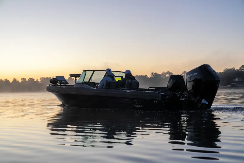 The Image of 2027 Warrior V208 boat cruising at sunrise on a calm lake. - 2