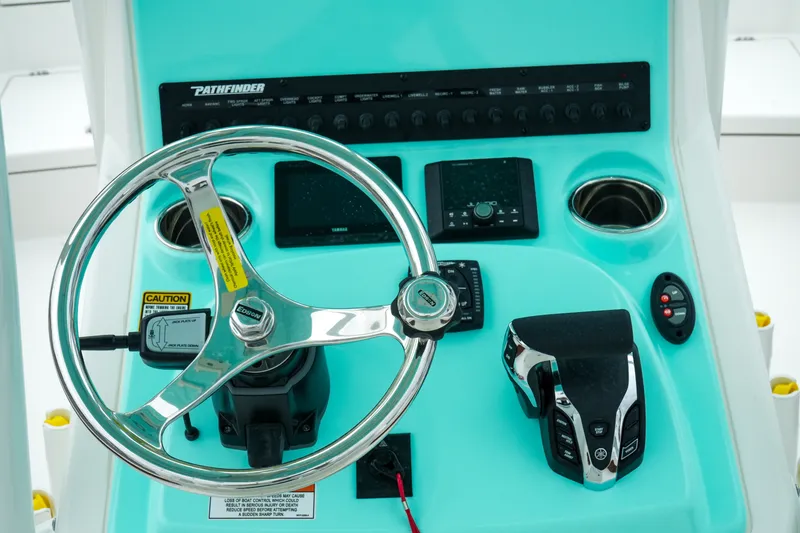 Slide: The Image of Steering console of 2027 Pathfinder 2500 Tournament boat with modern controls and displays. - 19