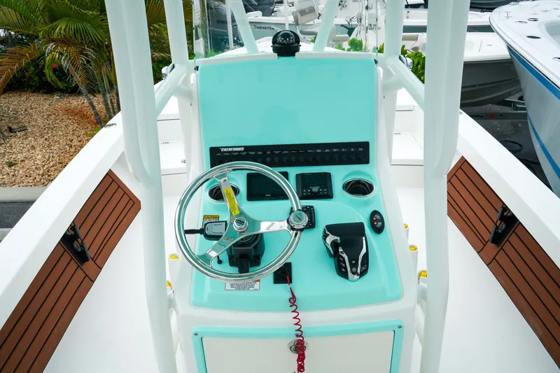 Slide: The Image of 2027 Pathfinder 2500 Tournament boat console with steering wheel and controls. - 18