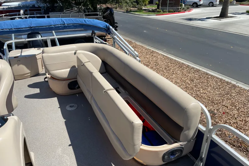 Slide: The Image of 2017 Sun Tracker Fishin' Barge 20 DLX with beige seating and storage compartments. - 21