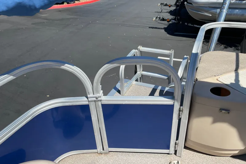 Slide: The Image of 2017 Sun Tracker Fishin' Barge 20 DLX pontoon boat with blue paneling and aluminum railing. - 17