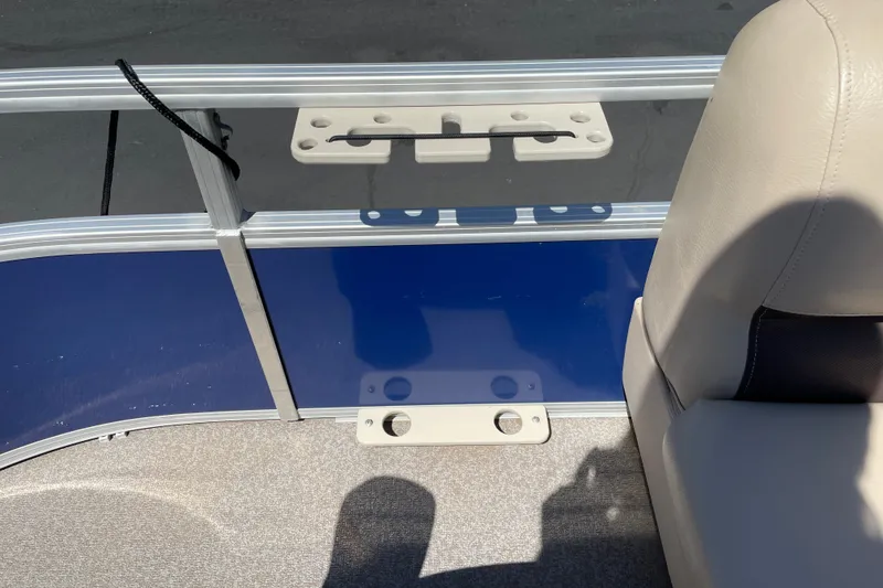 Slide: The Image of 2017 Sun Tracker Fishin' Barge 20 DLX interior with blue panel and beige seating. - 20