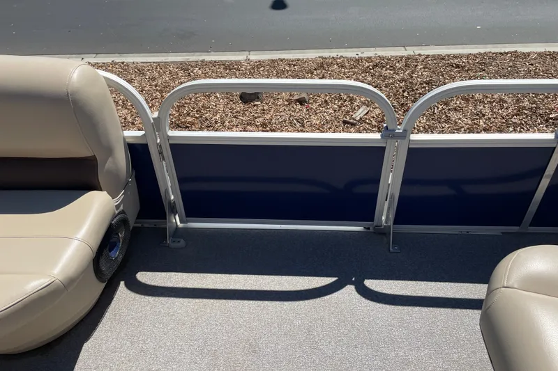 Slide: The Image of 2017 Sun Tracker Fishin' Barge 20 DLX interior with beige seating and blue paneling. - 25