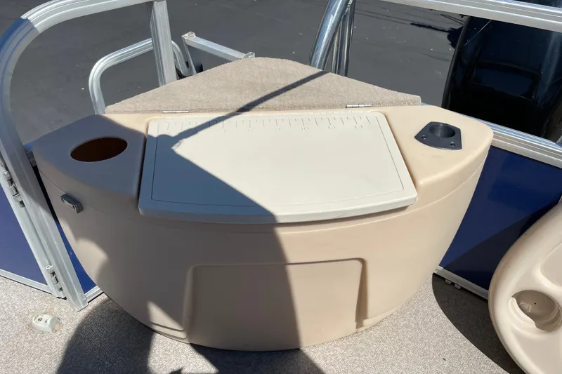 Slide: The Image of 2017 Sun Tracker Fishin' Barge 20 DLX boat console with storage and cup holders. - 13