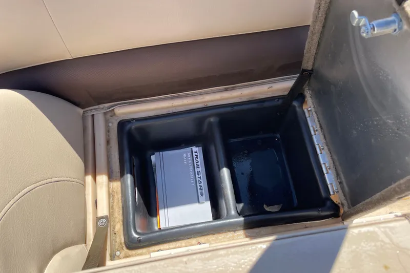 Slide: The Image of Storage compartment in a 2017 Sun Tracker Fishin' Barge 20 DLX with manual inside. - 22