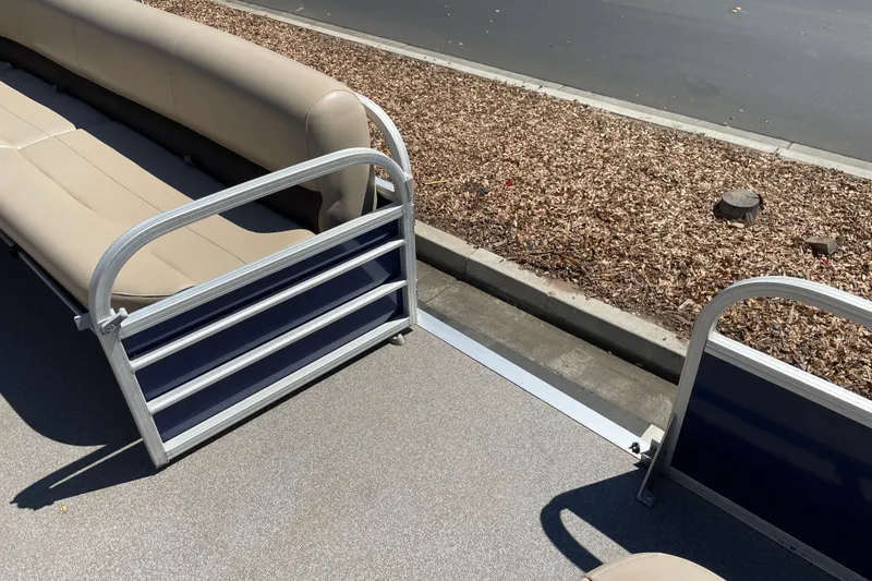 Slide: The Image of 2017 Sun Tracker Fishin' Barge 20 DLX interior with beige seating and metal railings. - 26