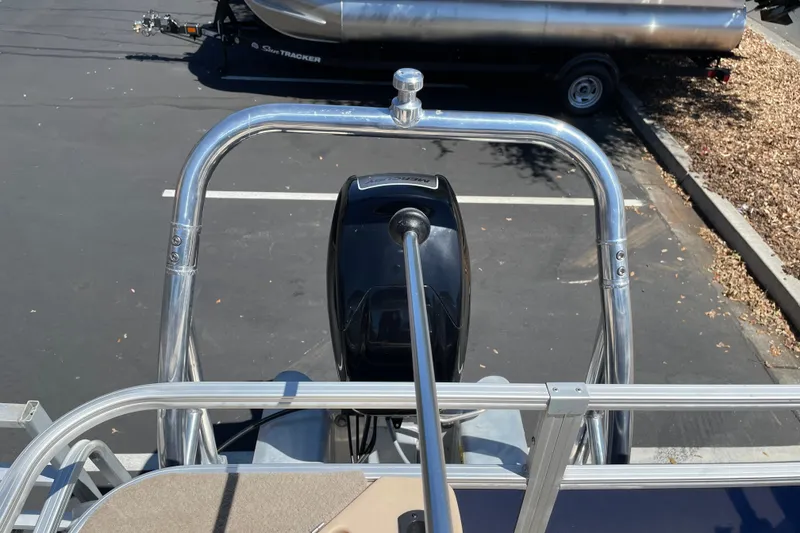 Slide: The Image of 2017 Sun Tracker Fishin' Barge 20 DLX boat with motor and railing in parking lot. - 27