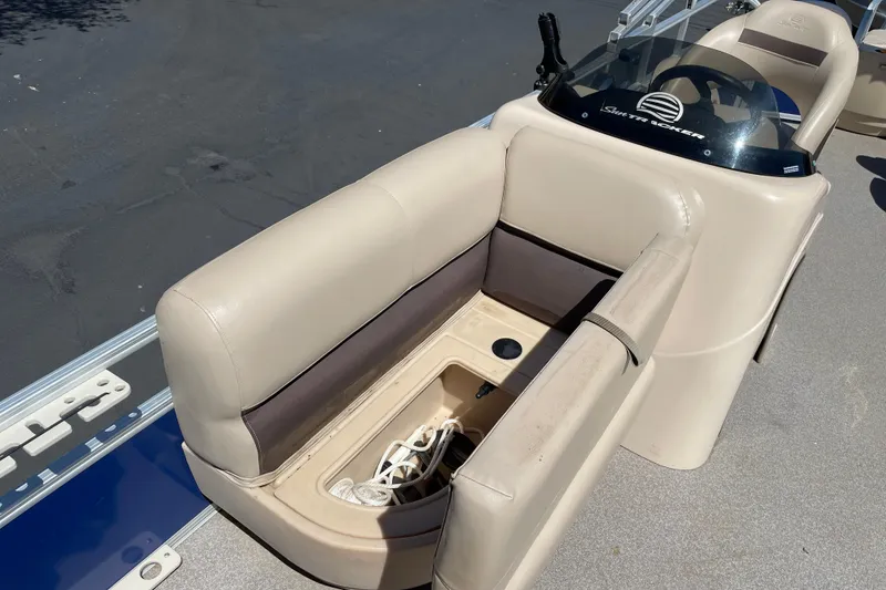Slide: The Image of 2017 Sun Tracker Fishin' Barge 20 DLX boat interior with beige seating and storage compartment. - 24