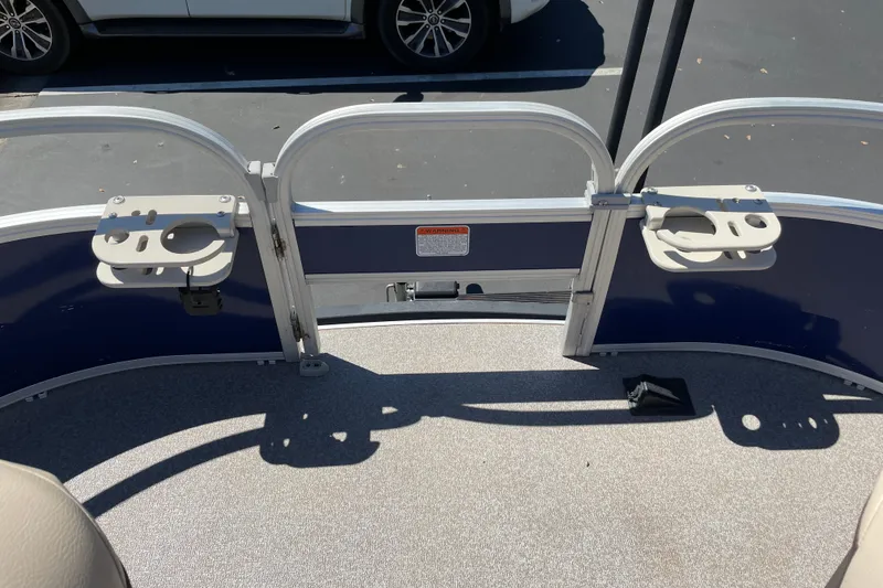 Slide: The Image of 2017 Sun Tracker Fishin' Barge 20 DLX deck with rod holders and seating area. - 19