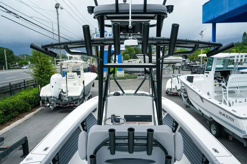 Slide: The Image of 2027 Pathfinder 2700 Tournament boat displayed at a dealership with other boats. - 19
