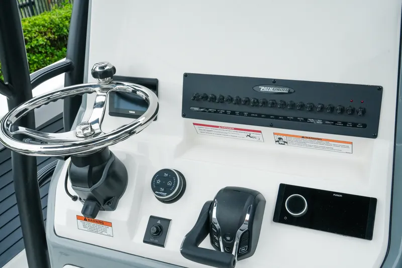 Slide: The Image of Dashboard of 2027 Pathfinder 2700 Tournament boat with steering wheel and controls. - 25