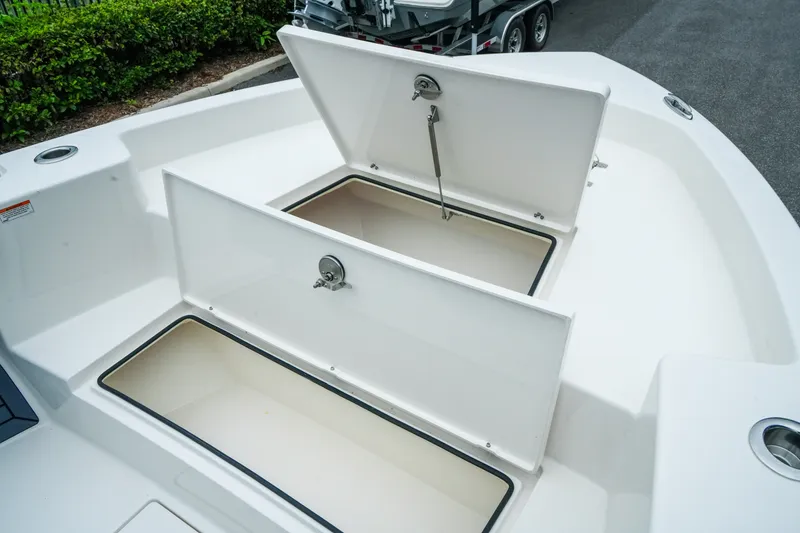 Slide: The Image of 2027 Pathfinder 2700 Tournament boat storage compartments open, showcasing spacious interior design. - 31