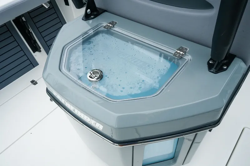 Slide: The Image of 2027 Pathfinder 2700 Tournament boat livewell with secure latch and transparent lid. - 23