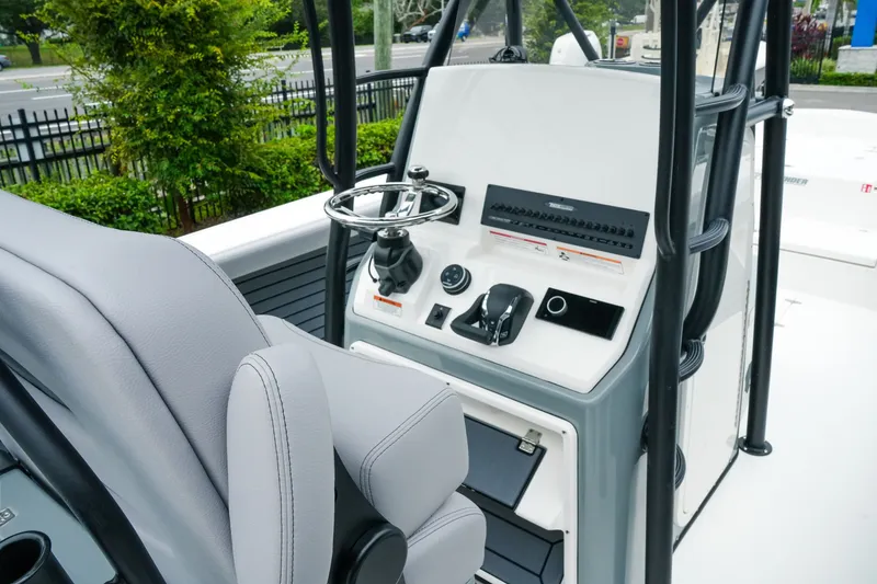 Slide: The Image of 2027 Pathfinder 2700 Tournament boat console with steering wheel and controls. - 24