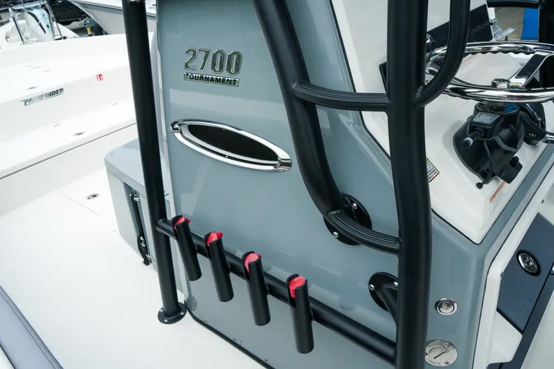 Slide: The Image of 2027 Pathfinder 2700 Tournament boat interior with rod holders and control panel. - 28