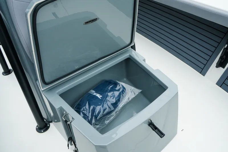 Slide: The Image of Open storage compartment on 2027 Pathfinder 2700 Tournament boat with packaged item inside. - 37