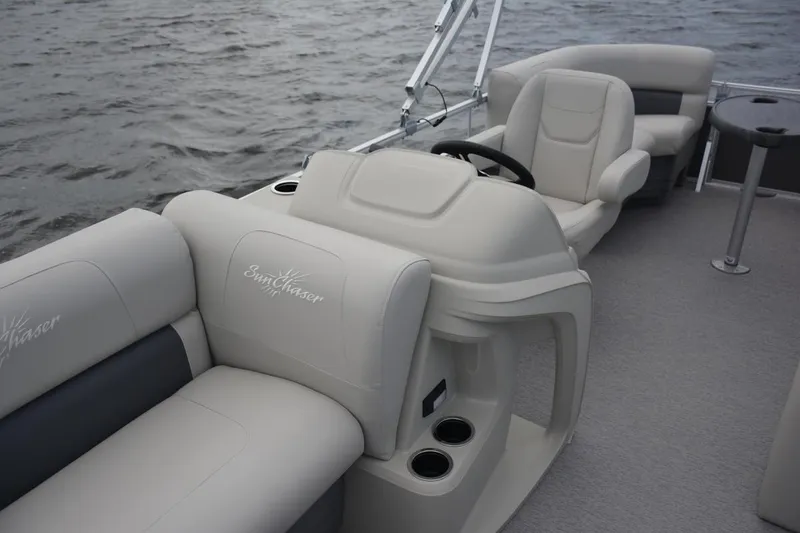 Slide: The Image of Manufacturer Provided Image: 2021 SunChaser Vista 20 LR boat interior with beige seating and steering console. - 5